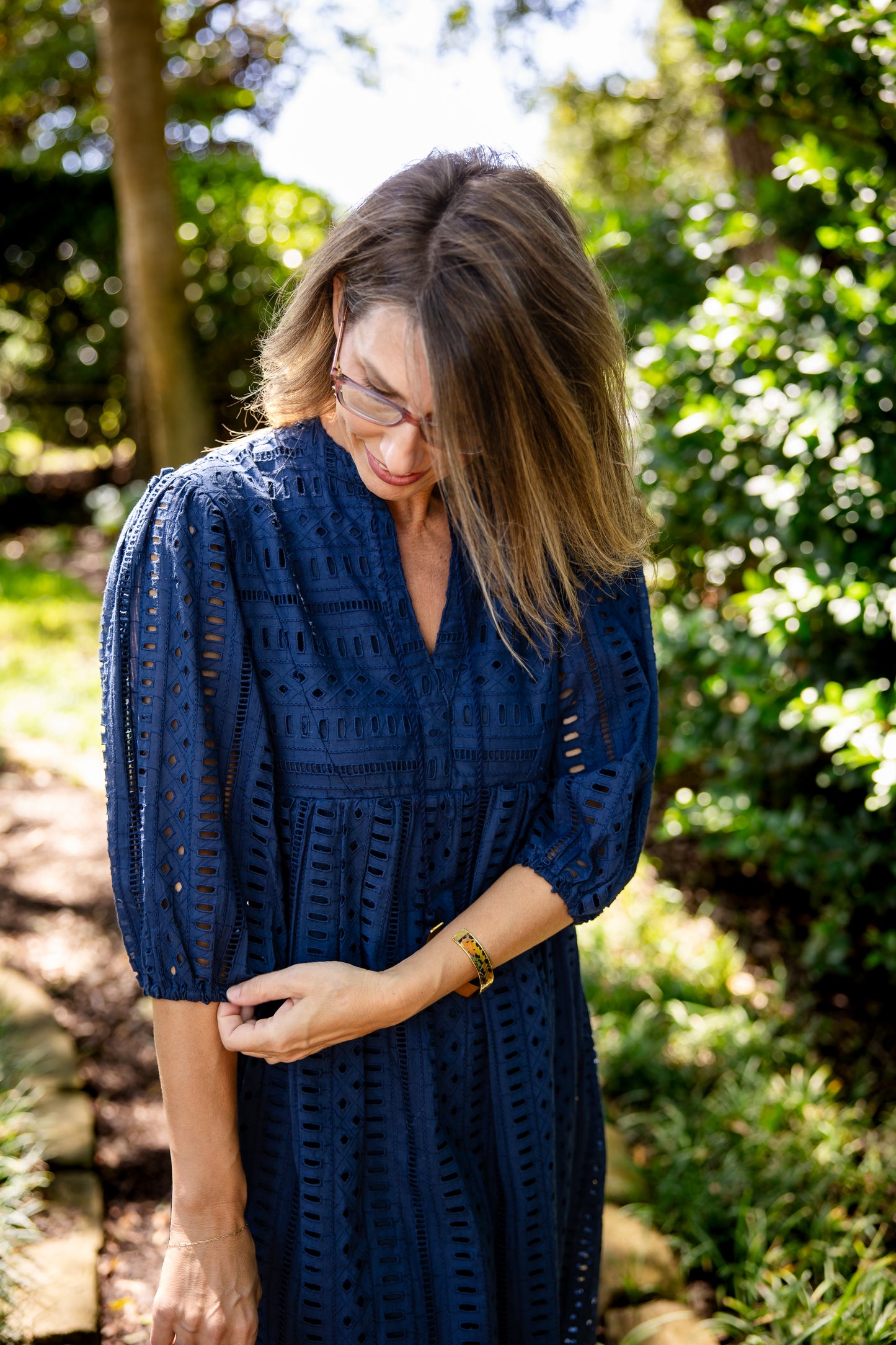 Woman wearing a blue dress standing in a garden